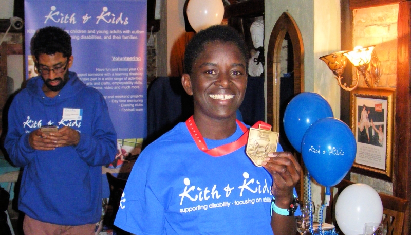 showing medal at post-run party